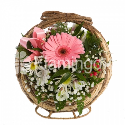 A basket of pink and white gerbera daisies, parrot flowers and chrysanthemums with green fillers