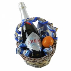 А decorated basket with champagne, chocolates and tangerines