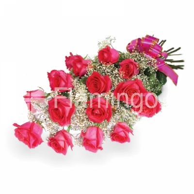 Pink roses arranged with baby breath and tied with a bow