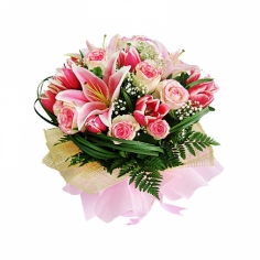 A nicely wrapped bouquet of pink lilies, roses and tulips