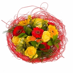 A nicely wrapped bouquet of yellow roses, yellow and red gerberas with green fillers