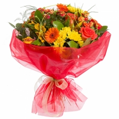 A bouquet of gerbera daisies, roses, chrysanthemums and parrot flowers of warm colors