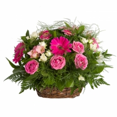 A basket of pink roses, parrot flowers and gerberas with green fillers