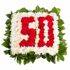 A bright number written in red carnations on the field of white chrysanthemums rimmed by green fillers