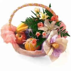 A basket with sparkling wine and fruits decorated with flowers