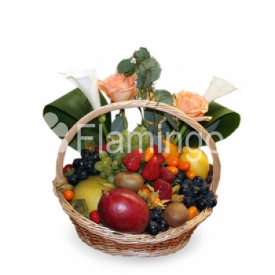 A basket with fruits, berries and red roses.