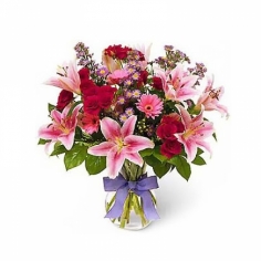 Asian pink lilies arranged with red spray roses and pink gerberas