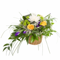 A basket arrangement with chrysanthemums, yellow roses, irises and green fillers
