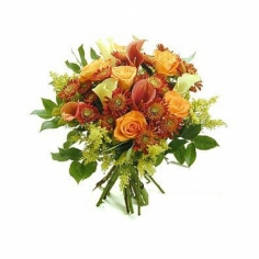 A bouquet of roses, calla lilies and chrysanthemums in red and gold colors