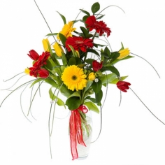 A bouquet of yellow and red tulips and gerbera daisies with green fillers
