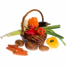 A basket full of fresh vegetables and greenery