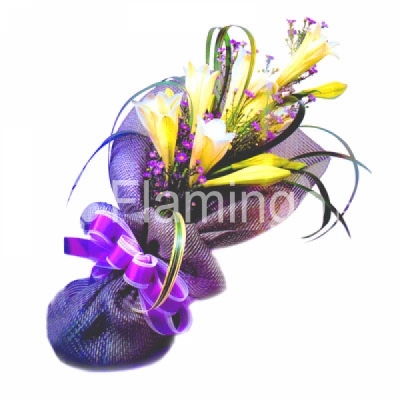 A bouquet of yellow lilies with green fillers wrapped  in purple