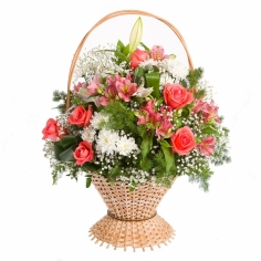 Pink roses and parrot flowers, white chrysanthemums and lilies in a basket