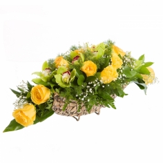 A basket with yellow roses, green orchids and green fillers
