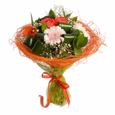 A bouquet of multicolored gerbera daisies and orange roses with green fillers beautifully wrapped