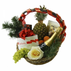 A bottle of Mondoro, quality chocolates and fruit arranged in a basket