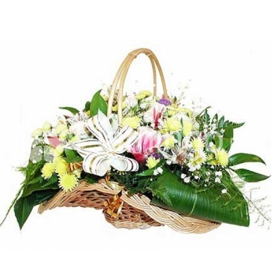 A basket with yellow chrysanthemums, pink parrot flowers and green fillers