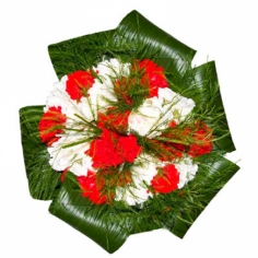 A round bouquet of red and white carnations with green fillers