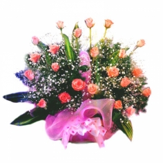 A nicely wrapped basket with pink roses and green fillers