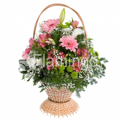 A basket of various pink and white flowers with green fillers