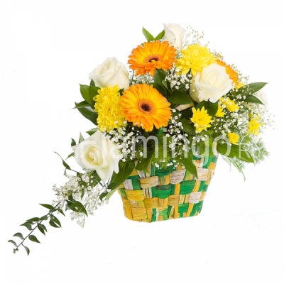 White roses, yellow gerbera daisies and chrysanthemums in a woven basket