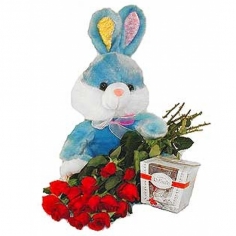 A bouquet of red roses, a box of ‘Raffaello’ and a toy bunny