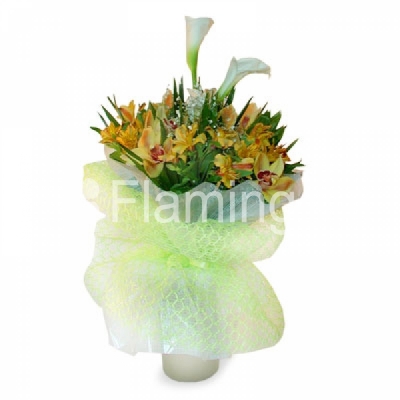 A nicely wrapped bouquet of white calla lilies, yellow parrot flowers and green orchids