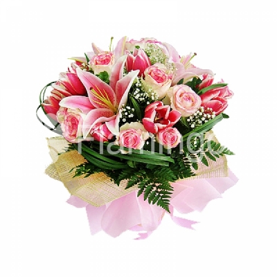 A nicely wrapped bouquet of pink lilies, roses and tulips