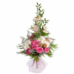 A bouquet of lightly colored roses, lilies and chrysanthemums with green fillers