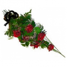 A funeral bouquet of roses and green fillers tied with a black bow