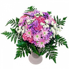 A pink and purple composition of chrysanthemums and carnations adorned with green fillers