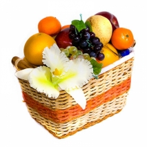 A basket of fruit and sweets decorated with flowers