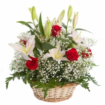 A basket with red roses, white lilies and green fillers