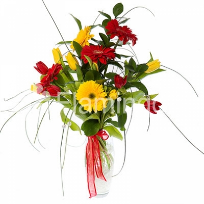 A bouquet of yellow and red tulips and gerbera daisies with green fillers